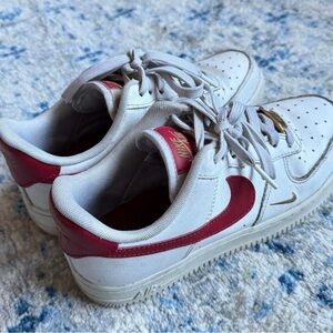 Nike Kids White Sneakers with Red Swoosh and Gold Detail